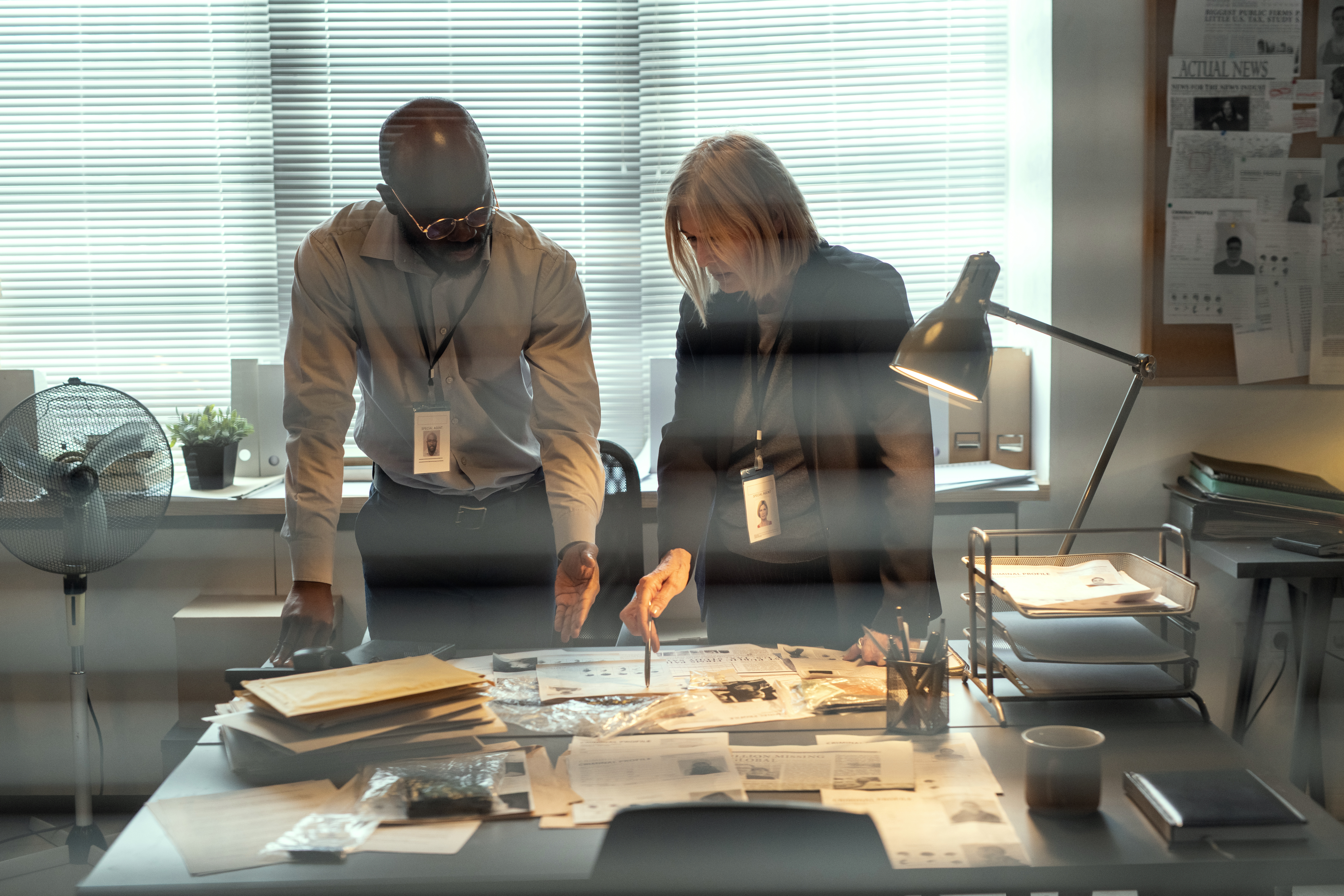 FBI agents look over a desk