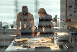 FBI agents look over a desk