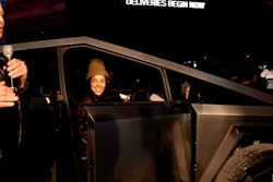 elon musk with customer delivered tesla cybertruck