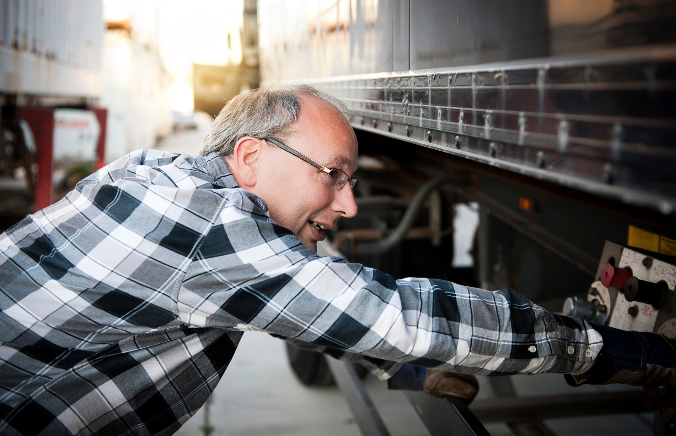 truck driver inspecting a trailer