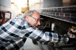 truck driver inspecting a trailer