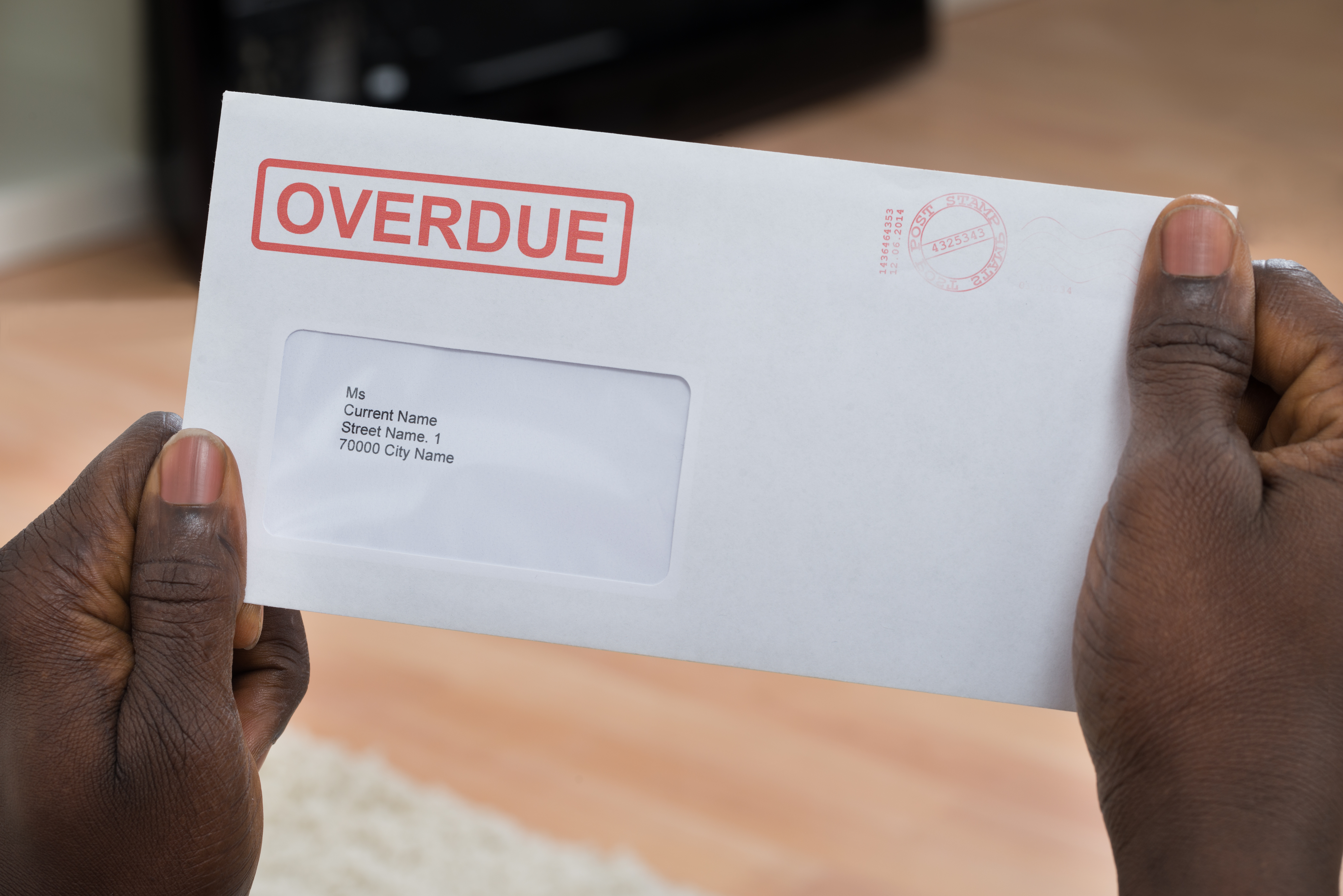 person holding a past due bill