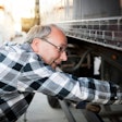 truck driver inspecting a trailer