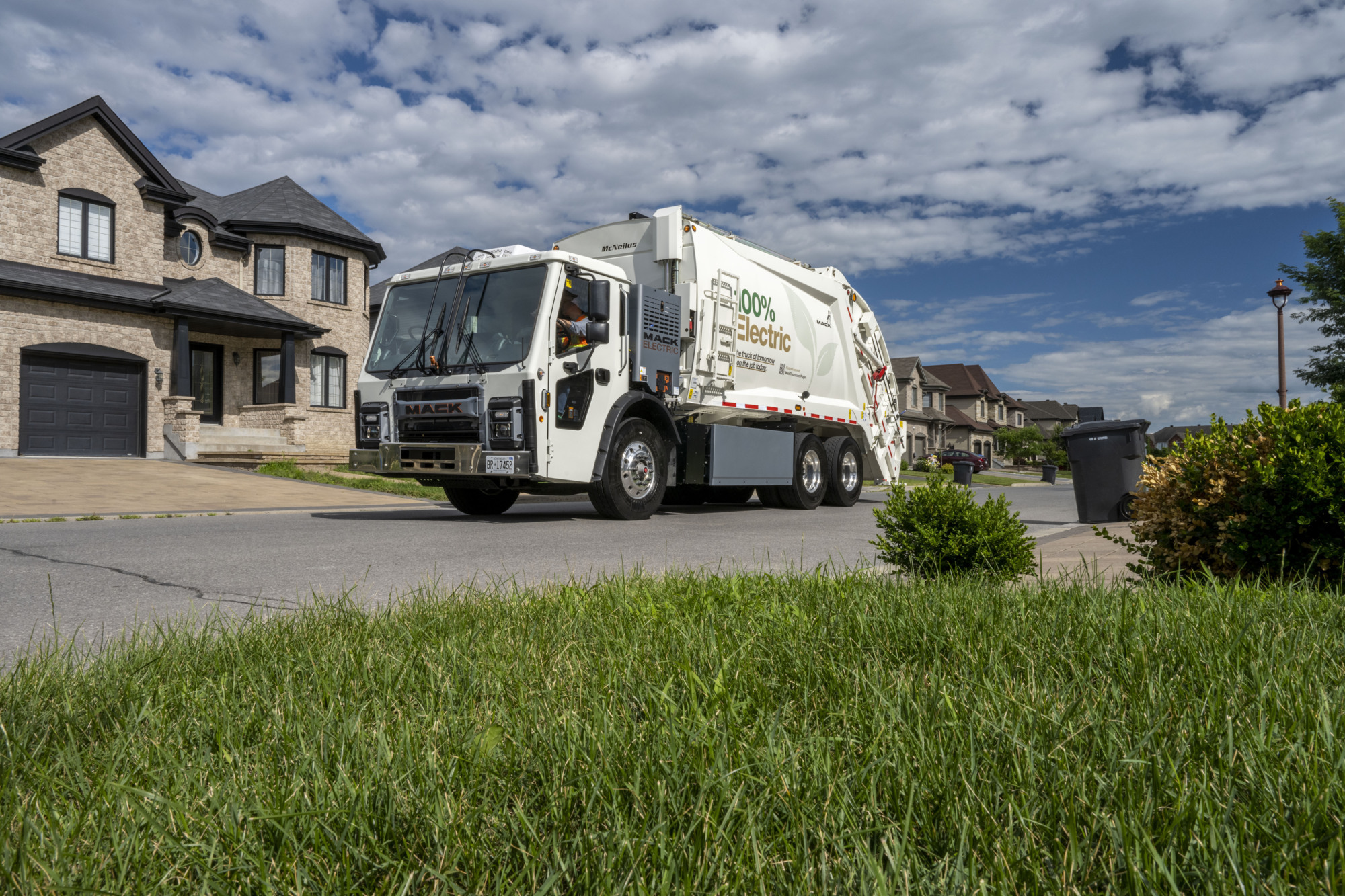 Mack LR Electric truck parked outside a private home.