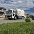 Mack LR Electric truck parked outside a private home.