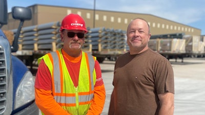 John Steffes, inbound materials coordinator at Chief Carriers, presenting driver Ron Jones with a red hat.