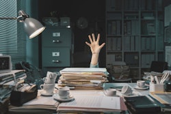 person buried under paperwork