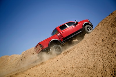 red 2024 Ram 2500 Power Wagon climbing dirt hill