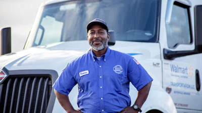Walmart driver poses in front of his truck