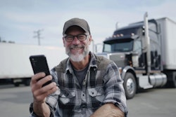 Older truck driver on a phone