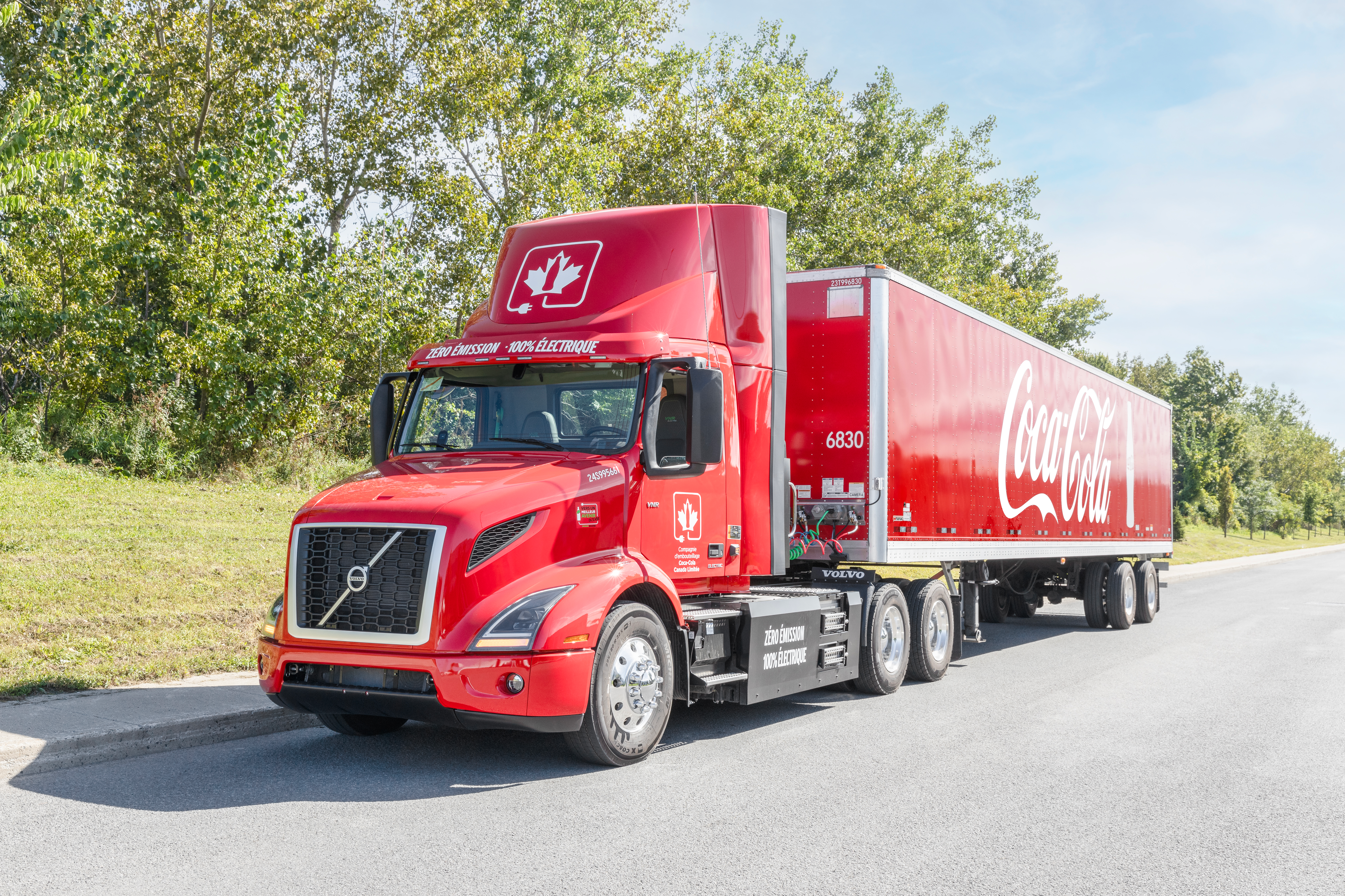 Coke-branded Volvo VNR Electric driving