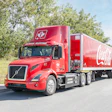 Coke-branded Volvo VNR Electric driving