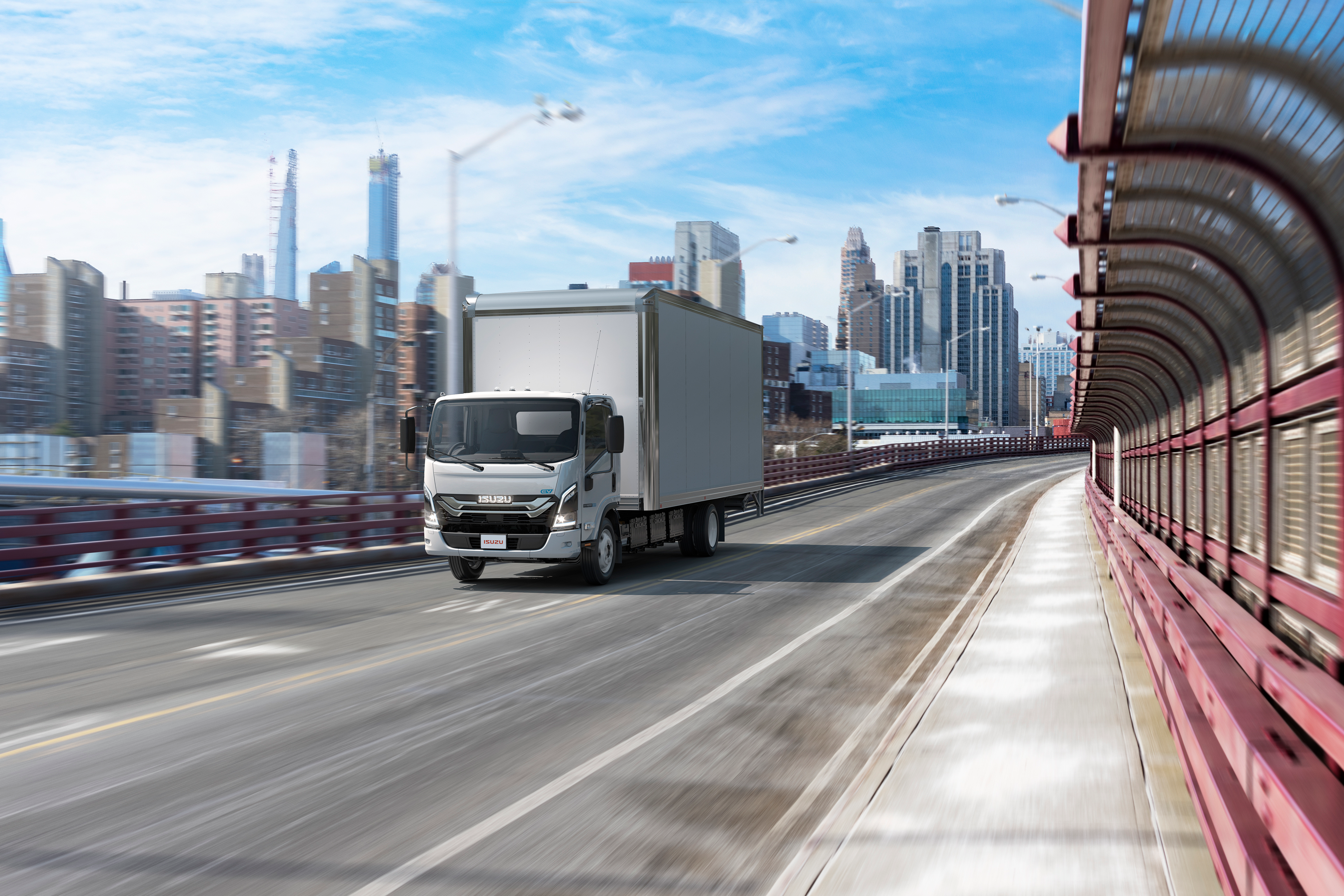 Isuzu's NRR-EV truck on highway in a city