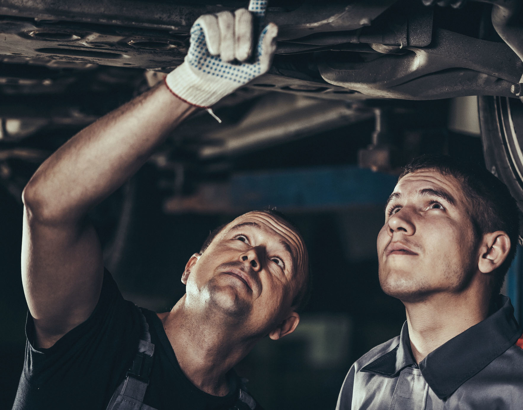 technicians looking at the undercarriage