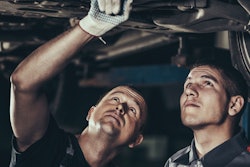 technicians looking at the undercarriage