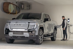 silver 2024 GMC Sierra Denali EV plugged in to charger