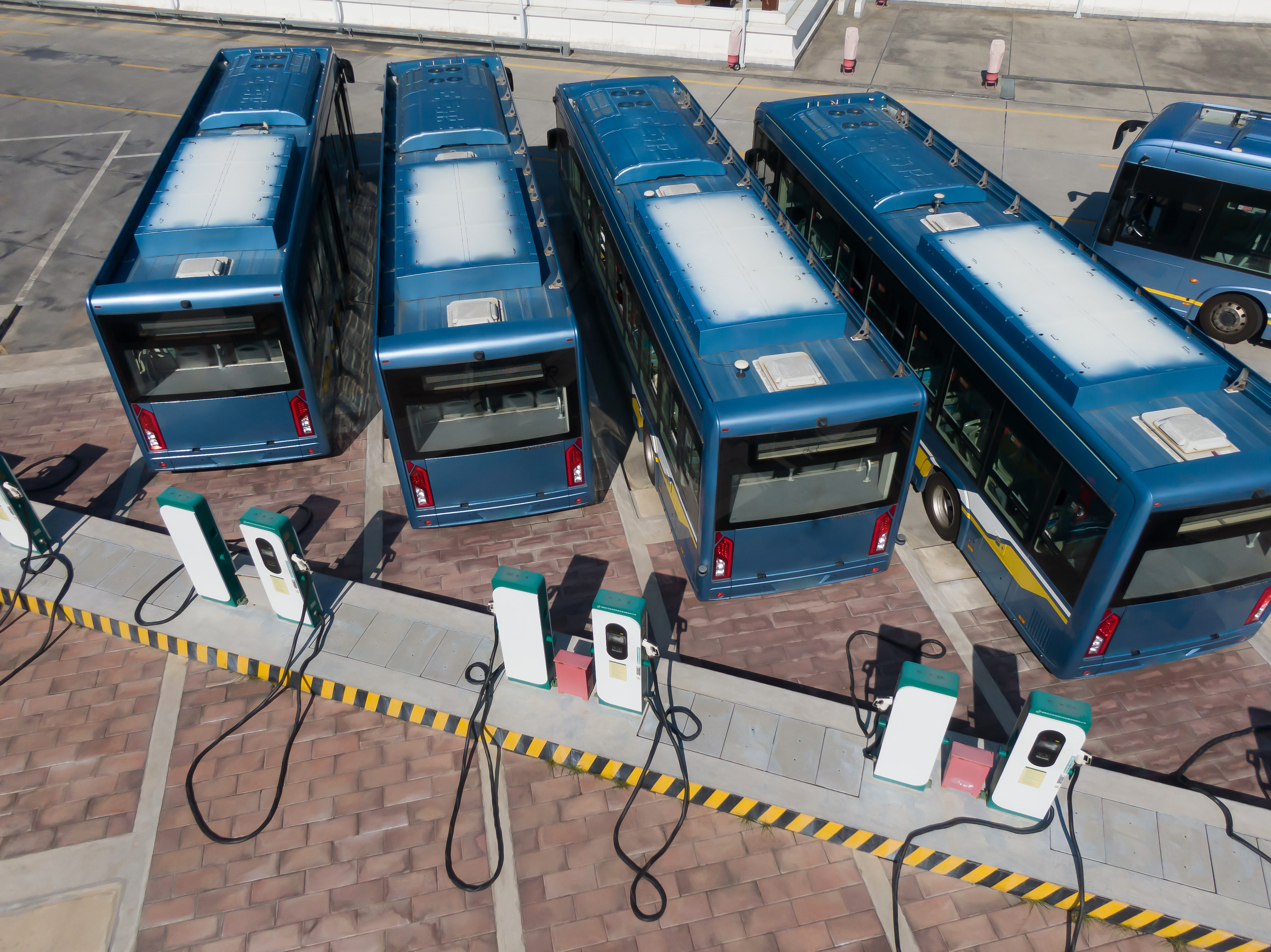 Electric transit buses parked and charging