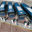 Electric transit buses parked and charging