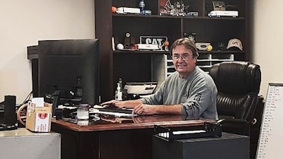 Steve Wilson, behind desk