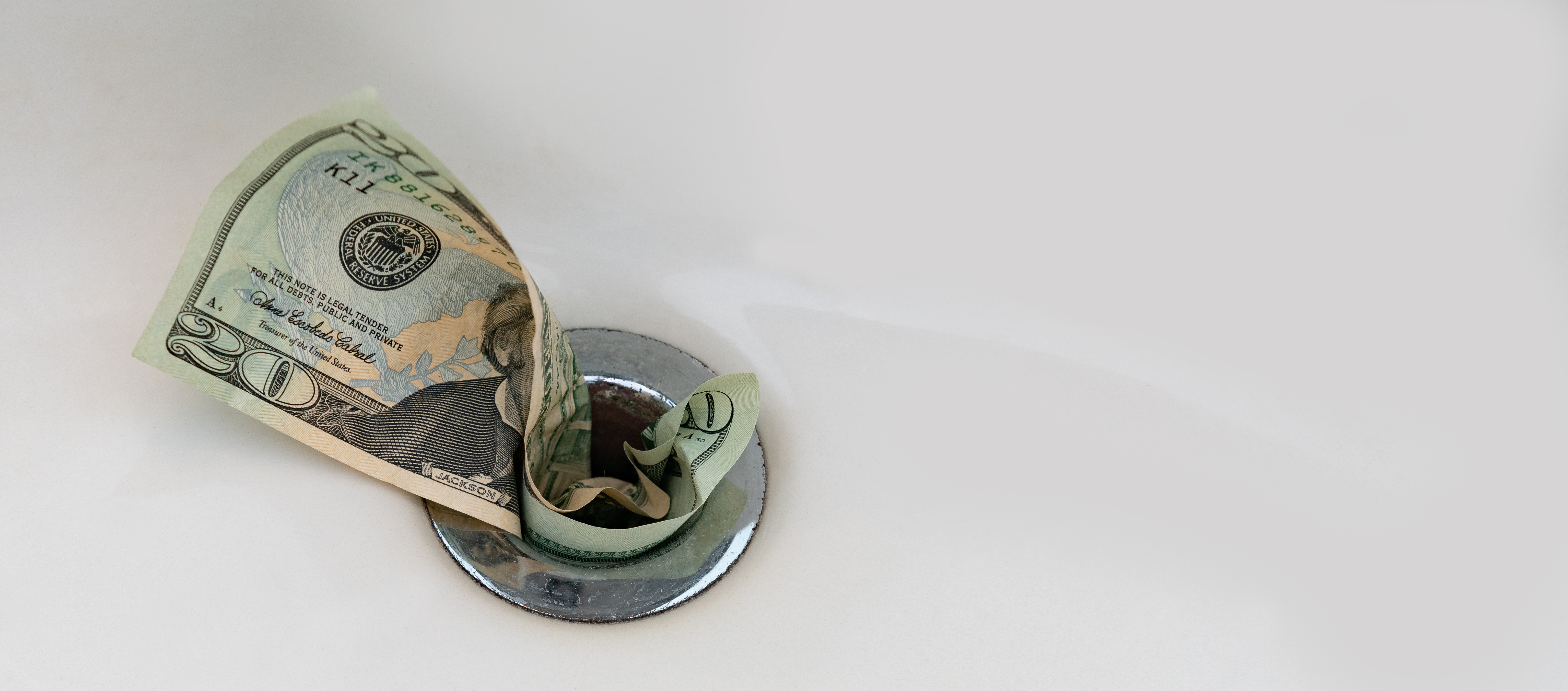 money going down a drain