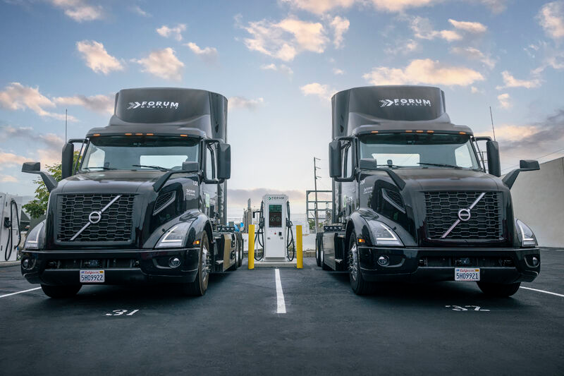A pair of EV semis charge