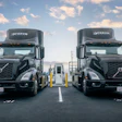 A pair of EV semis charge