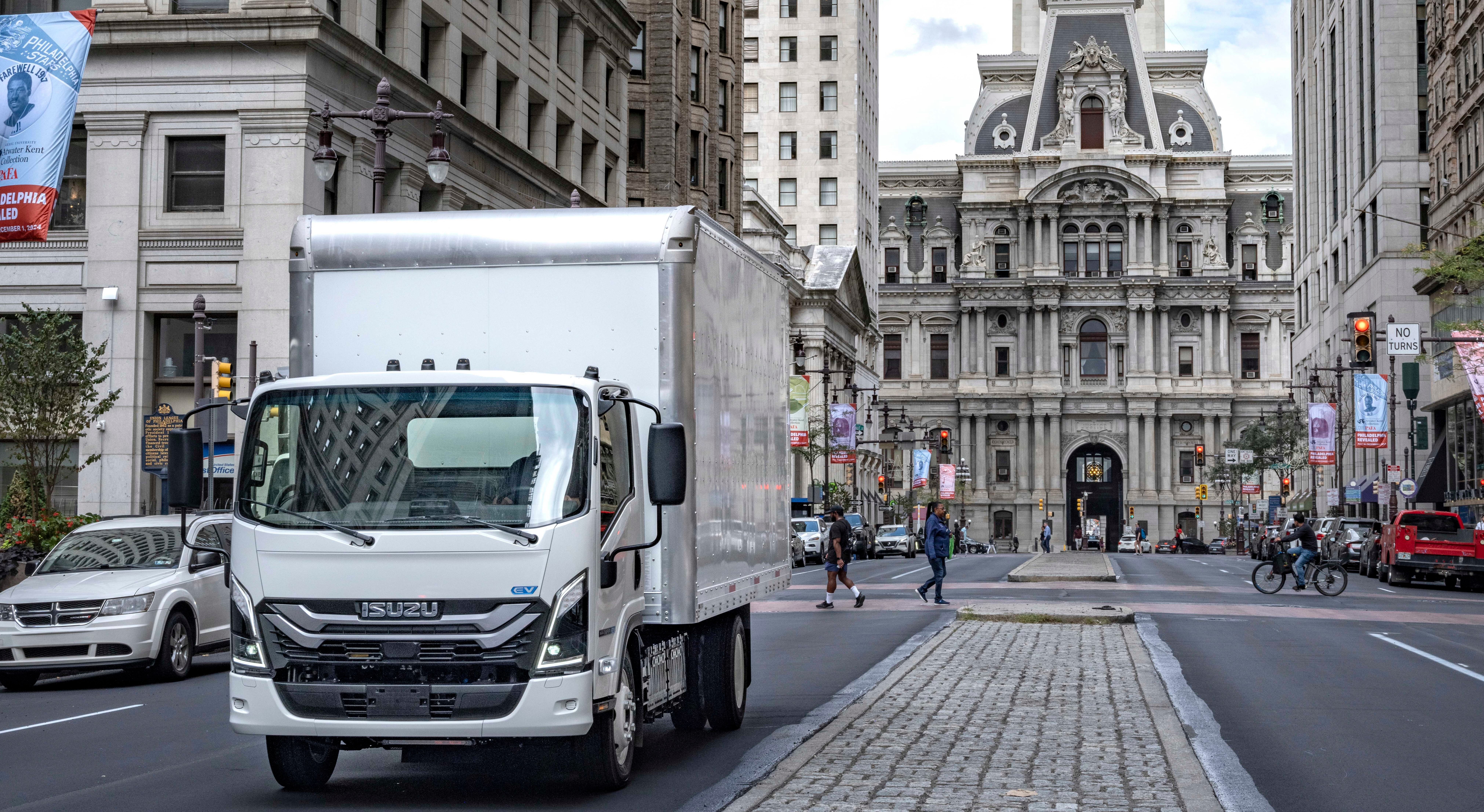 A truck driving down a city street.