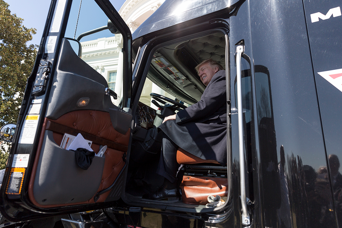 Donald Trump sitting in the cab of a semi truck
