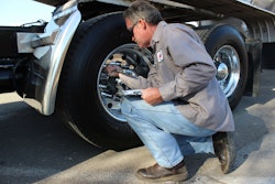Kelly Barwick checking tire pressure