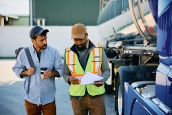 two truck drivers walking