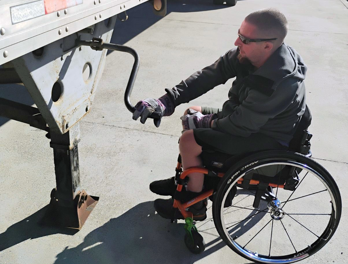 Truck driver Doug Teal lowers landing gear