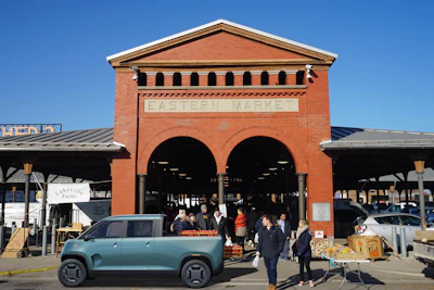 TELO Mt1 electric pickup parked in front of Eastern MArket building