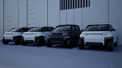 four electric TELO MT1 pickup trucks lined up front forward