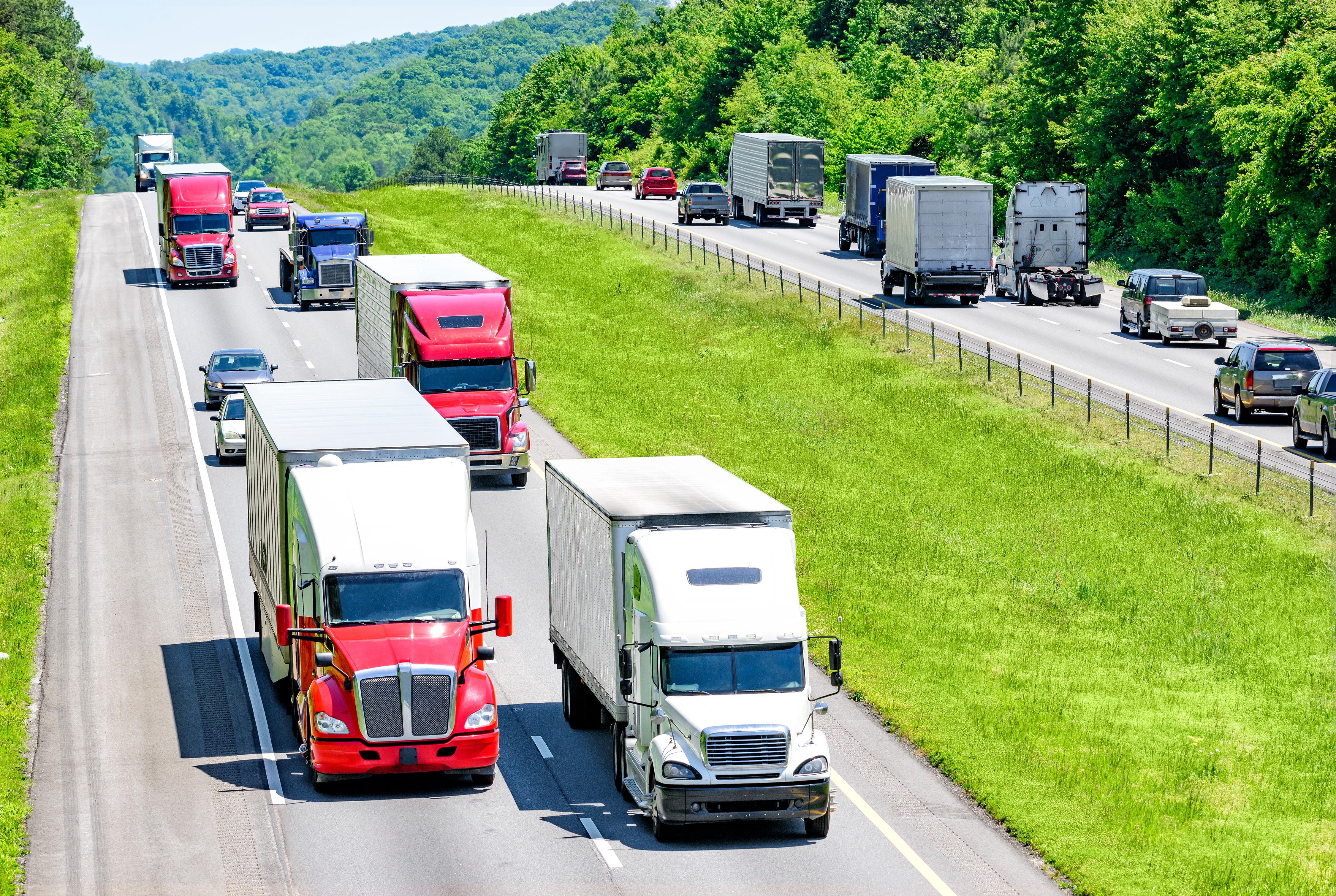 An interstate highway with traffic, including trucks.