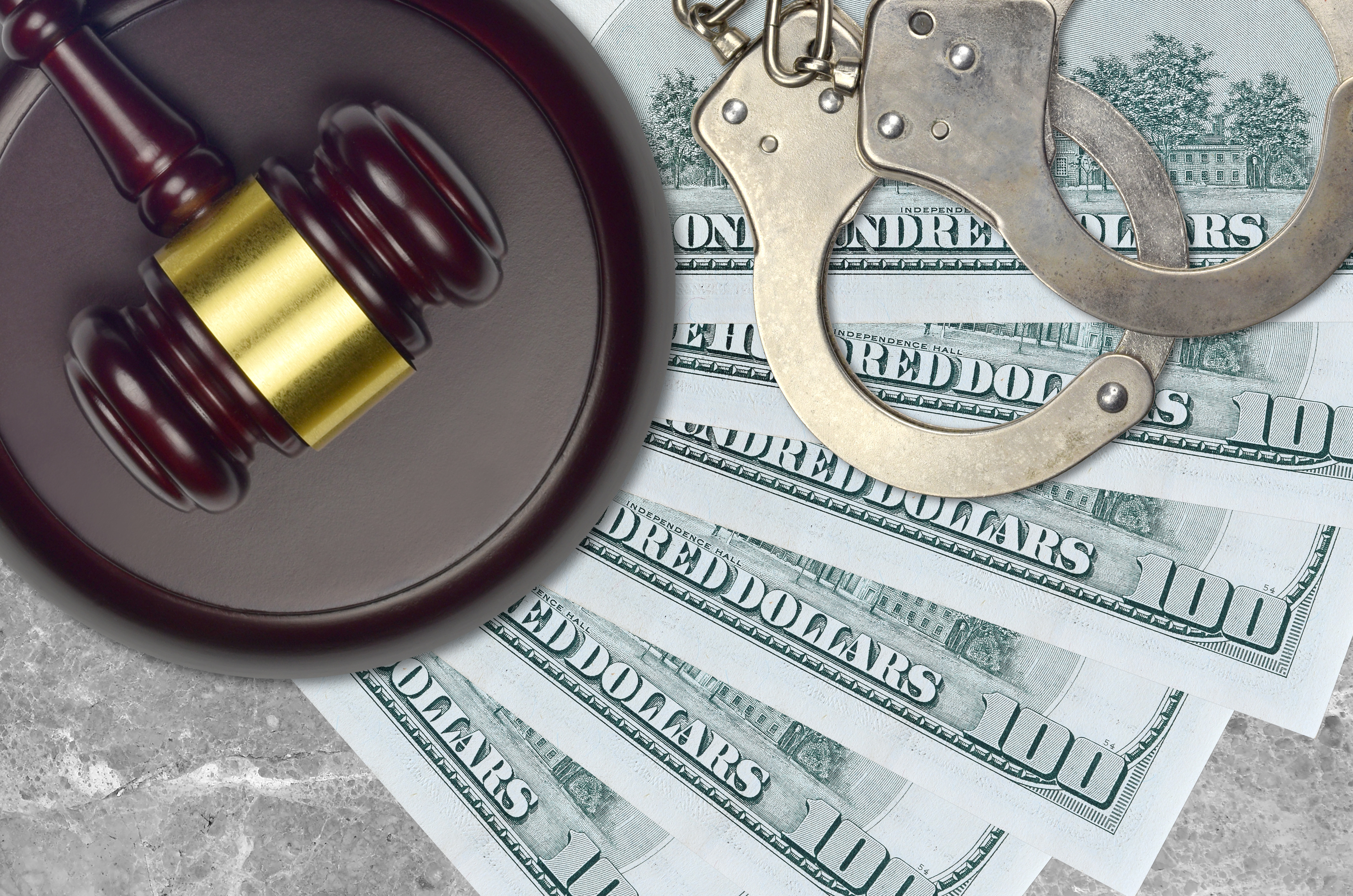 handcuffs with cash and gavel