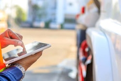 Construction worker using tablet for digital site documentation