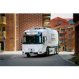 Volvo Electric Pre Zero waste collection truck parked on urban street with brick buildings