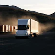 Tesla Semi kicking up dust near mountains