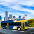 Blue and yellow public transit bus driving on highway with Dallas skyline in background