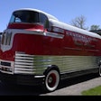 Classic red and white General Motors Futurliner bus from mid-20th century.