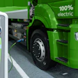 Green 100% electric truck connected to charging station