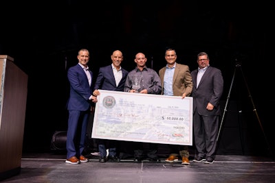 The 2025 Ryder Top Tech winner Kyle Walton holding his $50,000 check alongside Vice President of Maintenance Operations Bryce Kinsley; Chairman & CEO Robert Sanchez; President of Fleet Management Solutions Tom Havens; and Senior Vice President & Chief of Operations Bill Dawson.