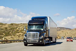 Blue Freightliner semi-truck driving on California highway