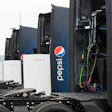 Tesla battery storage units and Semis with Pepsi branding in industrial setting