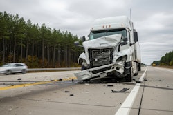Damaged white semi-truck after highway collision, debris scattered on road