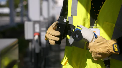 A ChargeHelp! technician is shown testing an EV charging connector.