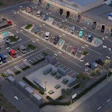 Aerial view of EV Realty charging hub with multiple electric vehicles at charging stations