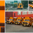 Yellow school buses parked at depot with electric charging station