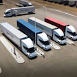 Multiple Uber Freight Tesla Semi trucks parked in a logistics yard with white, blue, and red trailers