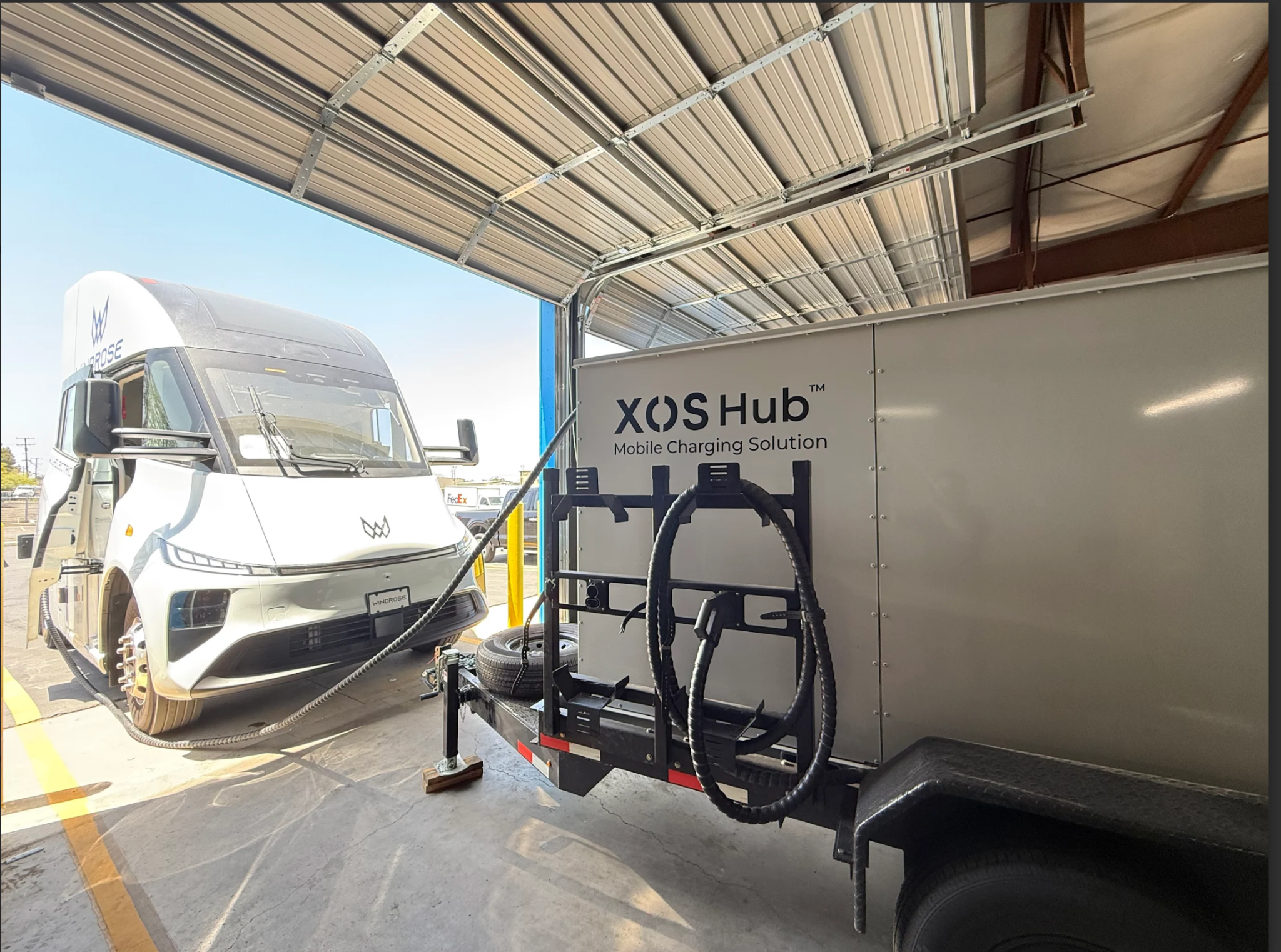 The Xos Hub delivers power to a Windrose electric truck through a mobile charging setup.